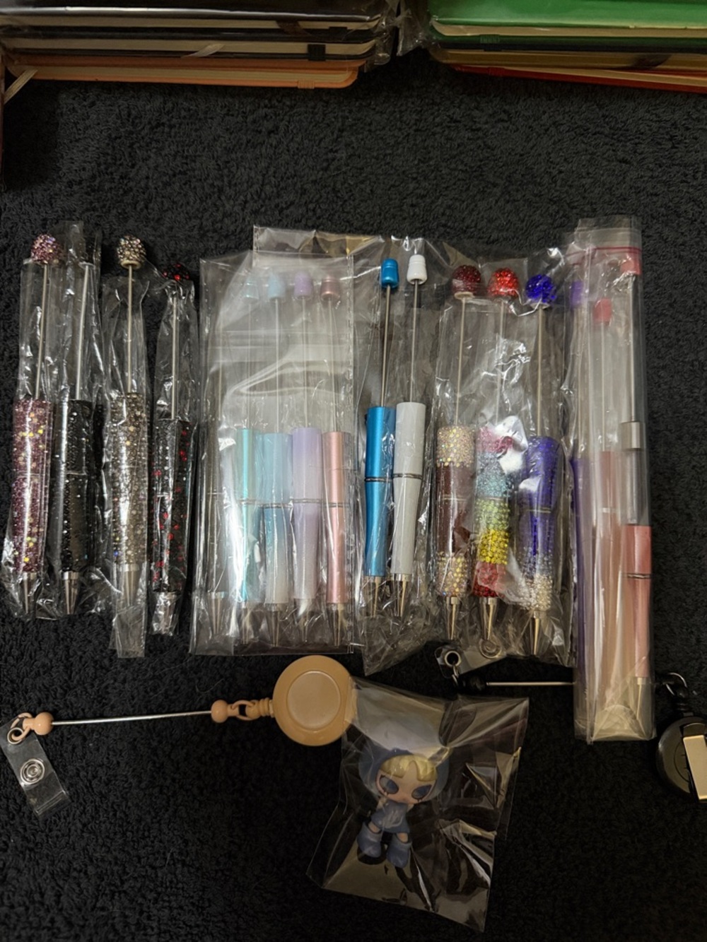 Assorted Beadable Pens 2 badge reels and a Inns figure